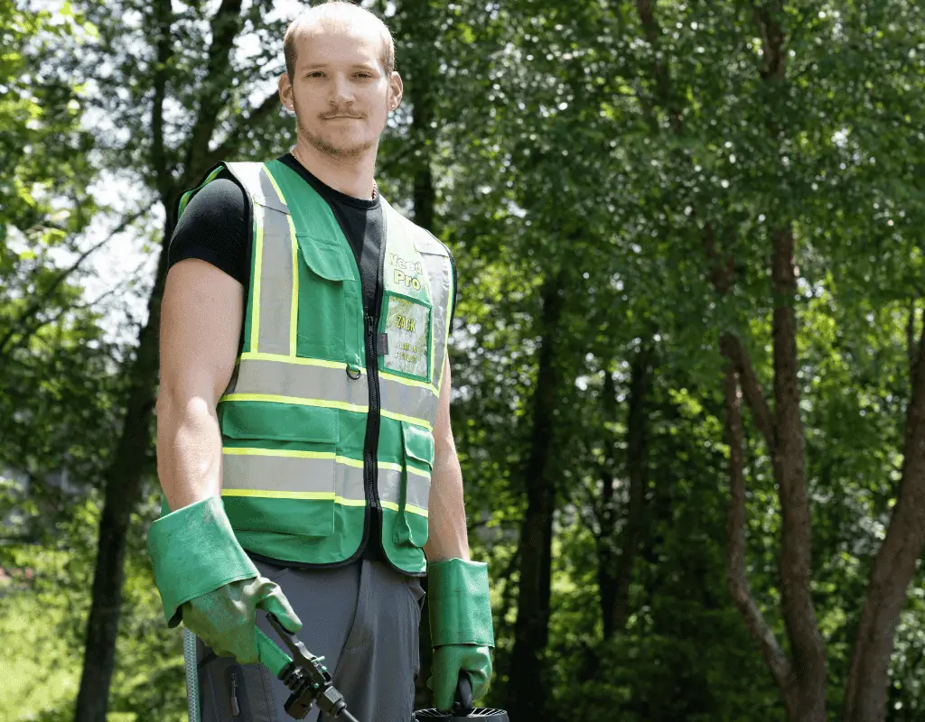 A vibrant planting of pink and yellow impatiens under a hedge, exemplifying the lush growth supported by WeedPro’s irrigation solutions.