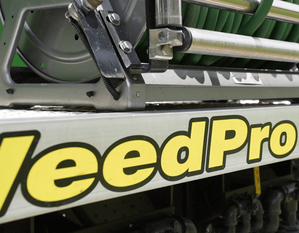 Detail of a WeedPro service truck’s hose reel and mounted sprayer, ready for pre-emergent herbicide application to block weed germination.