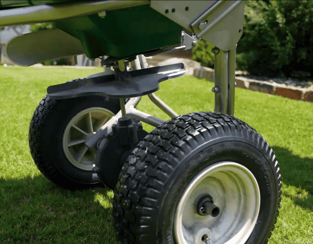 Overseeding machine wheels and spreader mechanism moving across an Atlanta, GA lawn as part of WeedPro’s overseeding process.