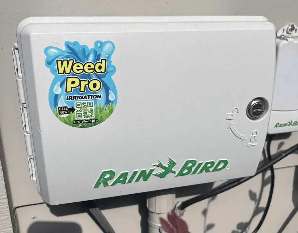 Pop-up sprinkler head watering healthy green grass