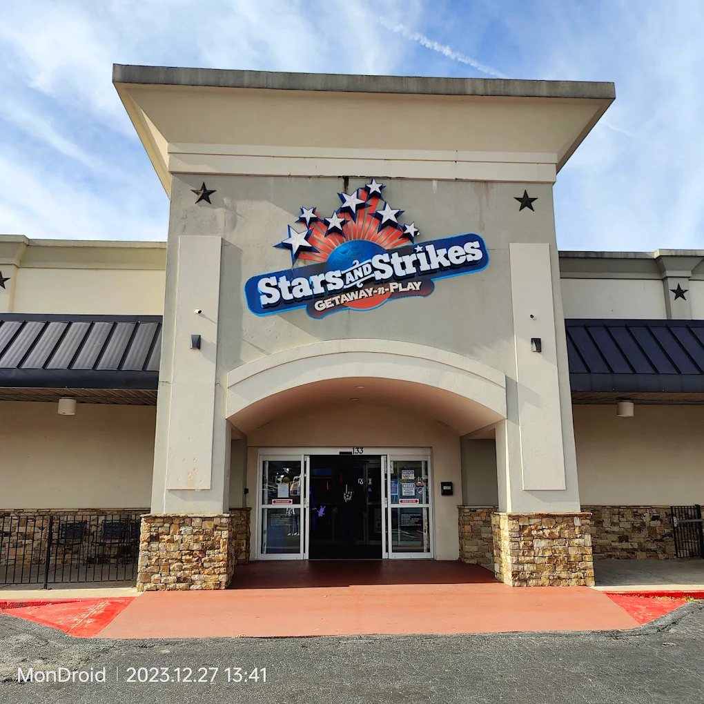 Stars and Strikes entrance in Cumming, GA, featuring the logo and vibrant signage, inviting families for entertainment and fun activities.