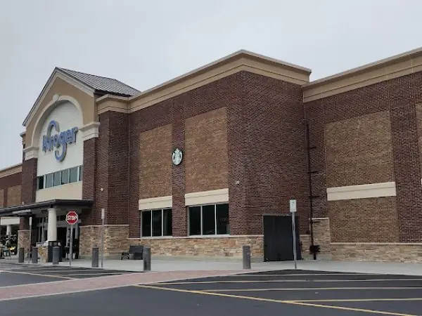 Kroger grocery store exterior with brick facade, clock, and entrance signage, located in Gwinnett County, GA, highlighting local shopping options.
