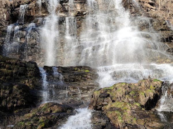 Waterfall cascading over rocky terrain in Dawson County, GA, showcasing natural beauty and lush greenery.