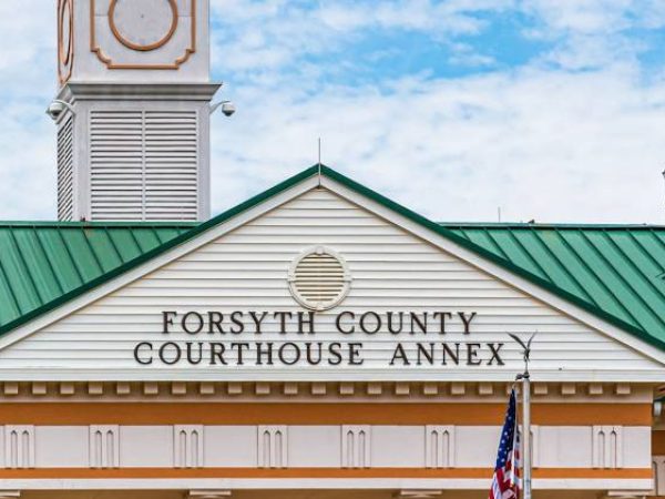 Forsyth County Courthouse Annex building with green roof and clock tower, representing local government in Forsyth County, GA, relevant to Weed Pro Lawn Care service area.