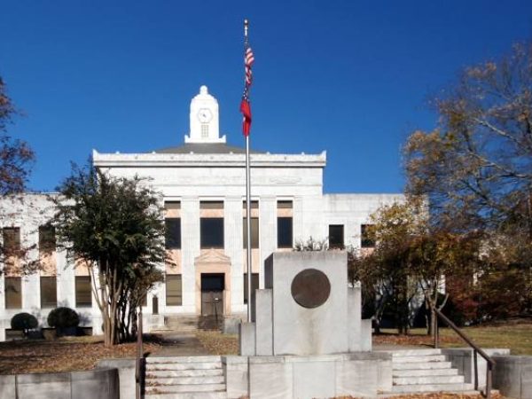 Historic Gainesville, GA courthouse building with flagpole and monument, representing the local government and community heritage.